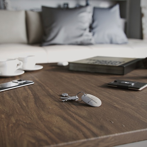 Ajax SpaceControl key fob in a modern living room